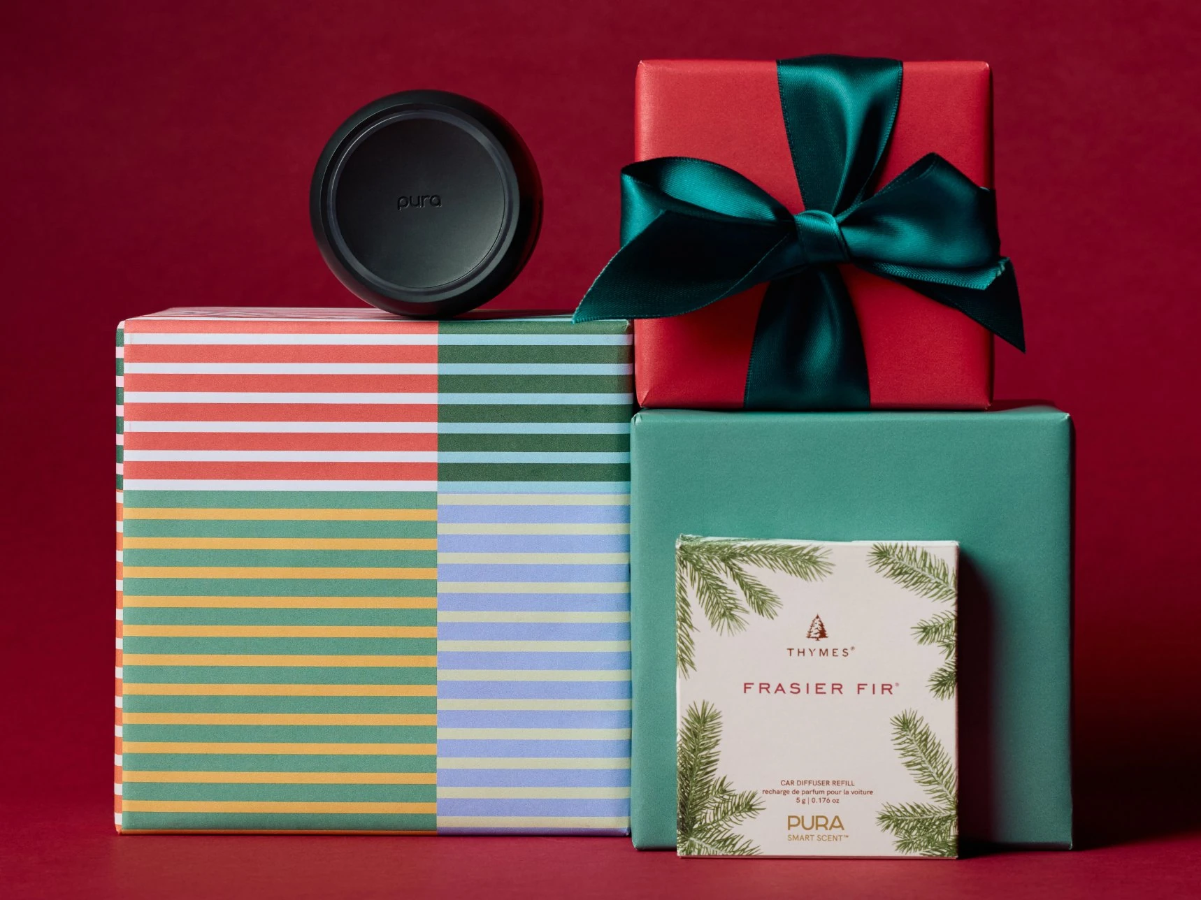 An overhead flat-lay of Pura fragrance vial boxes from brands including Anthropologie, Capri Blue, Thymes, and Votivo.