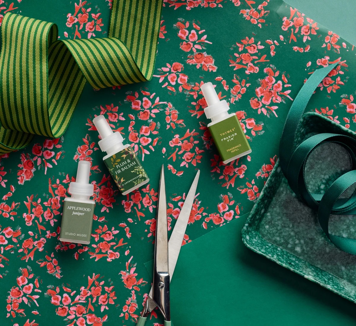 An overhead flat-lay of Pura fragrance vial boxes from brands including Anthropologie, Capri Blue, Thymes, and Votivo.
