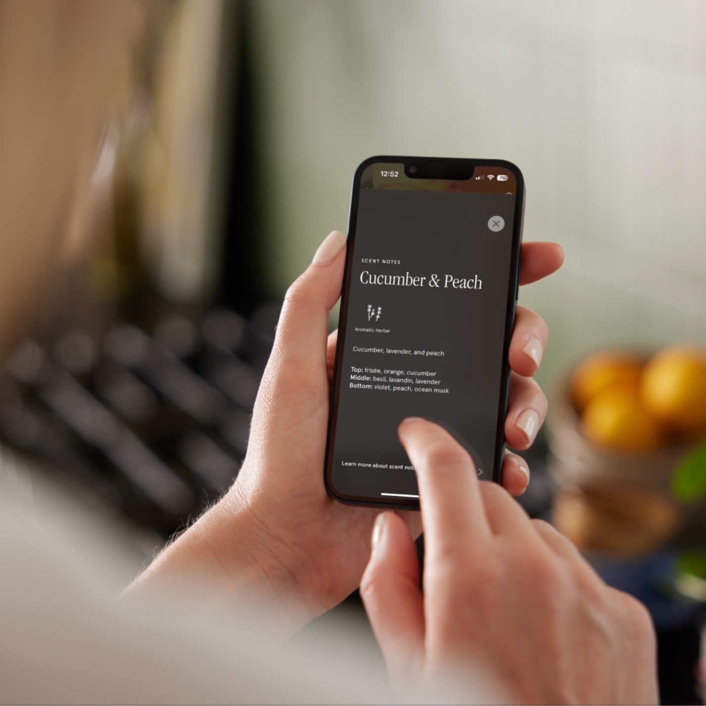 Pura app and fragrance diffusing shown on phone screen